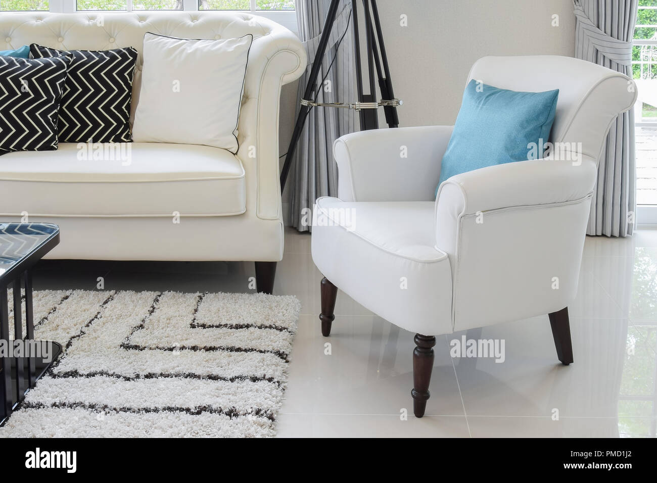 White And Blue Pillows On A White Leather Couch In Vintage