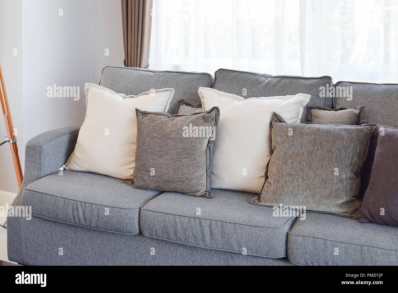 modern living room design with gray sofa and decorative pillows Stock