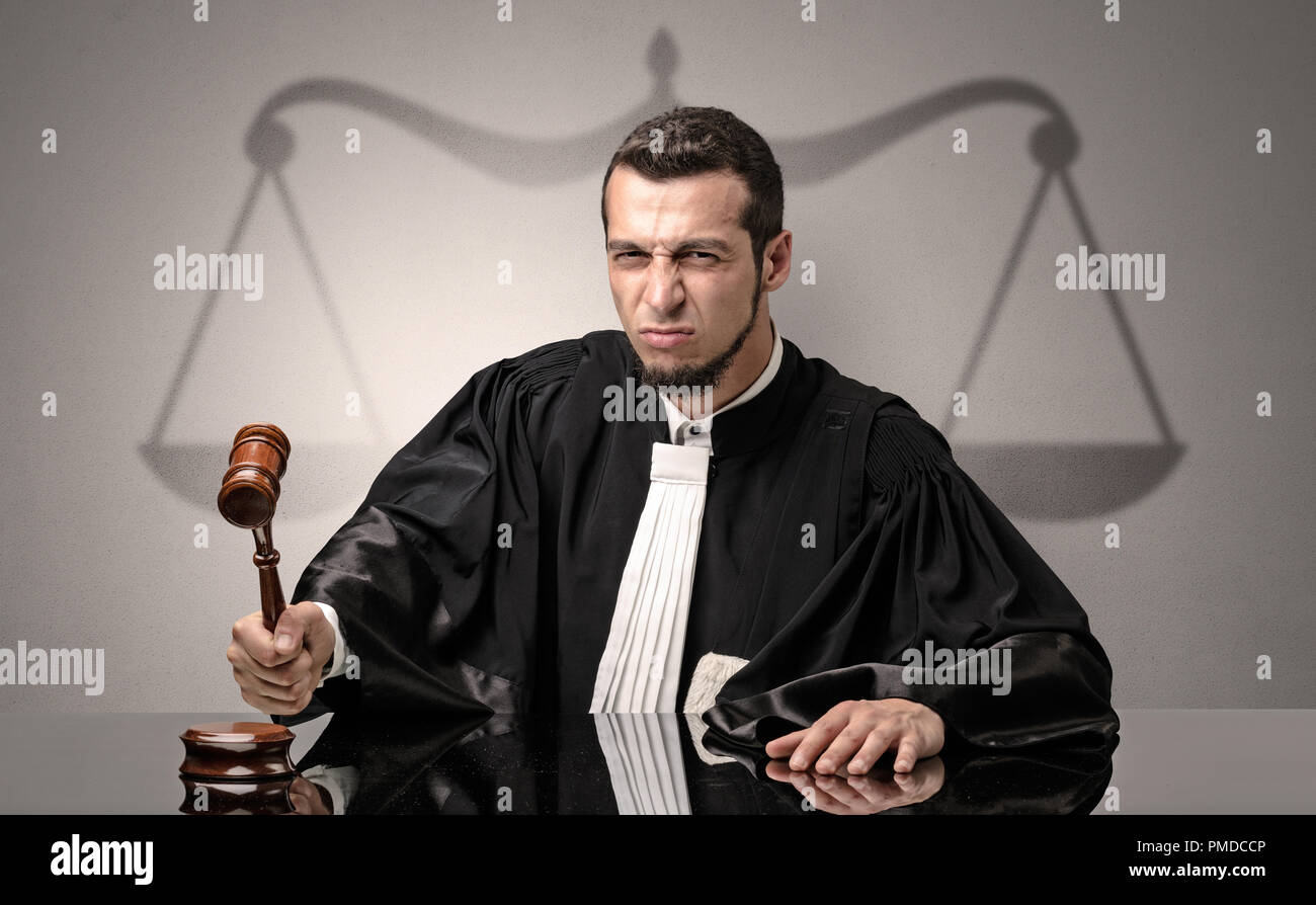 Young handsome judge in black gown making decision Stock Photo
