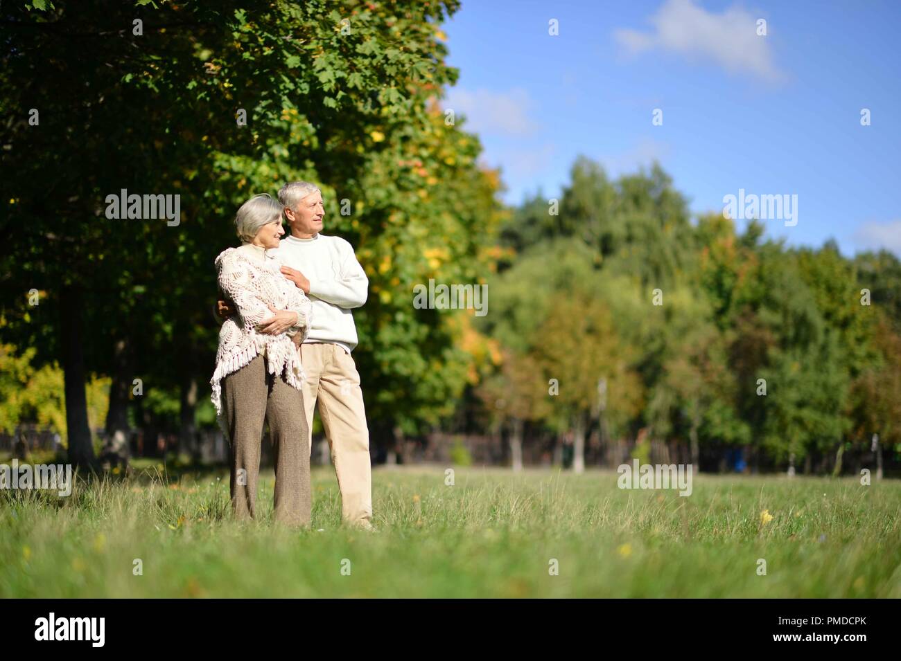 Elderly couple walking in park hi-res stock photography and images - Alamy