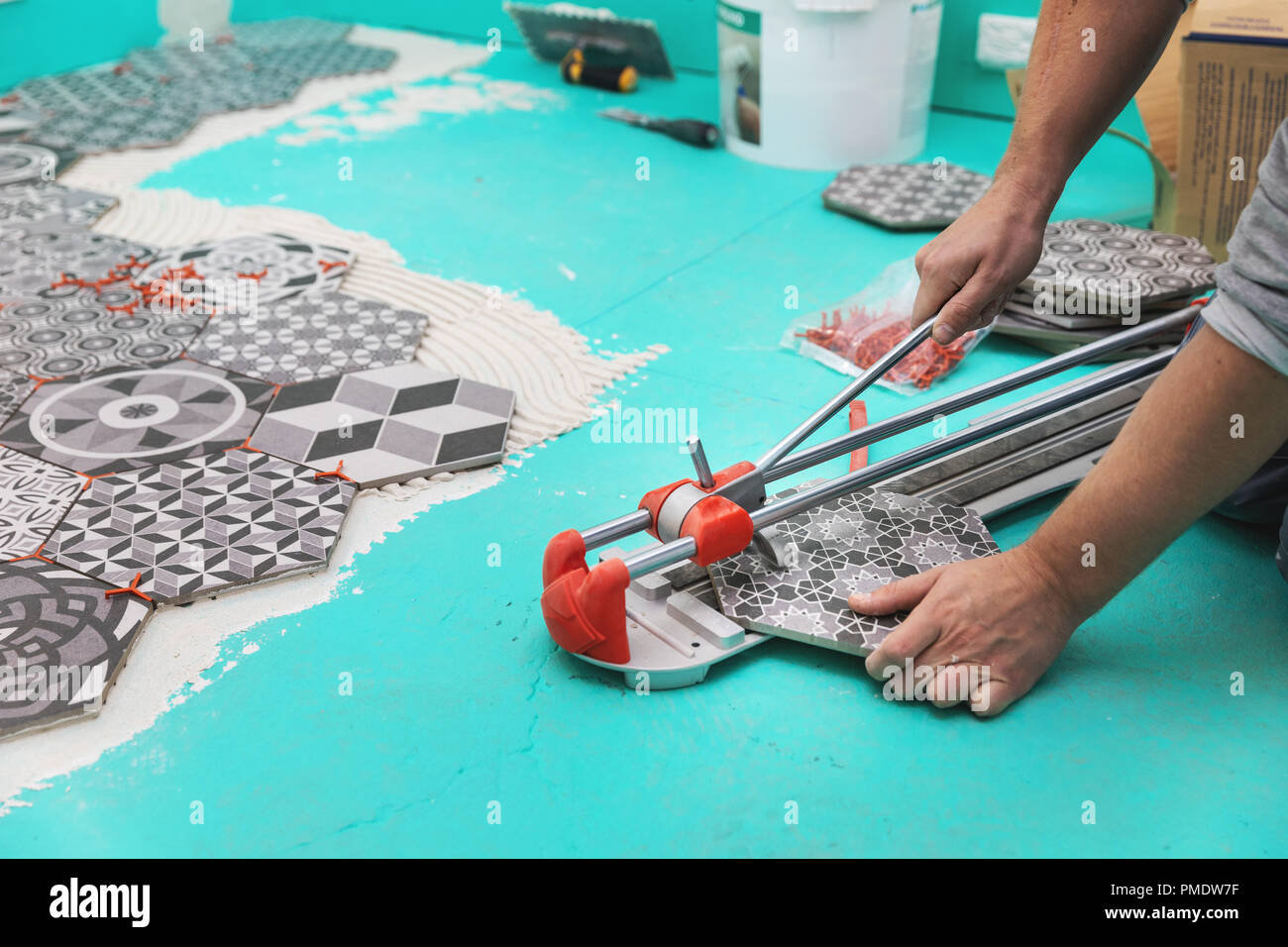 tiler cutting tile with cutter Stock Photo