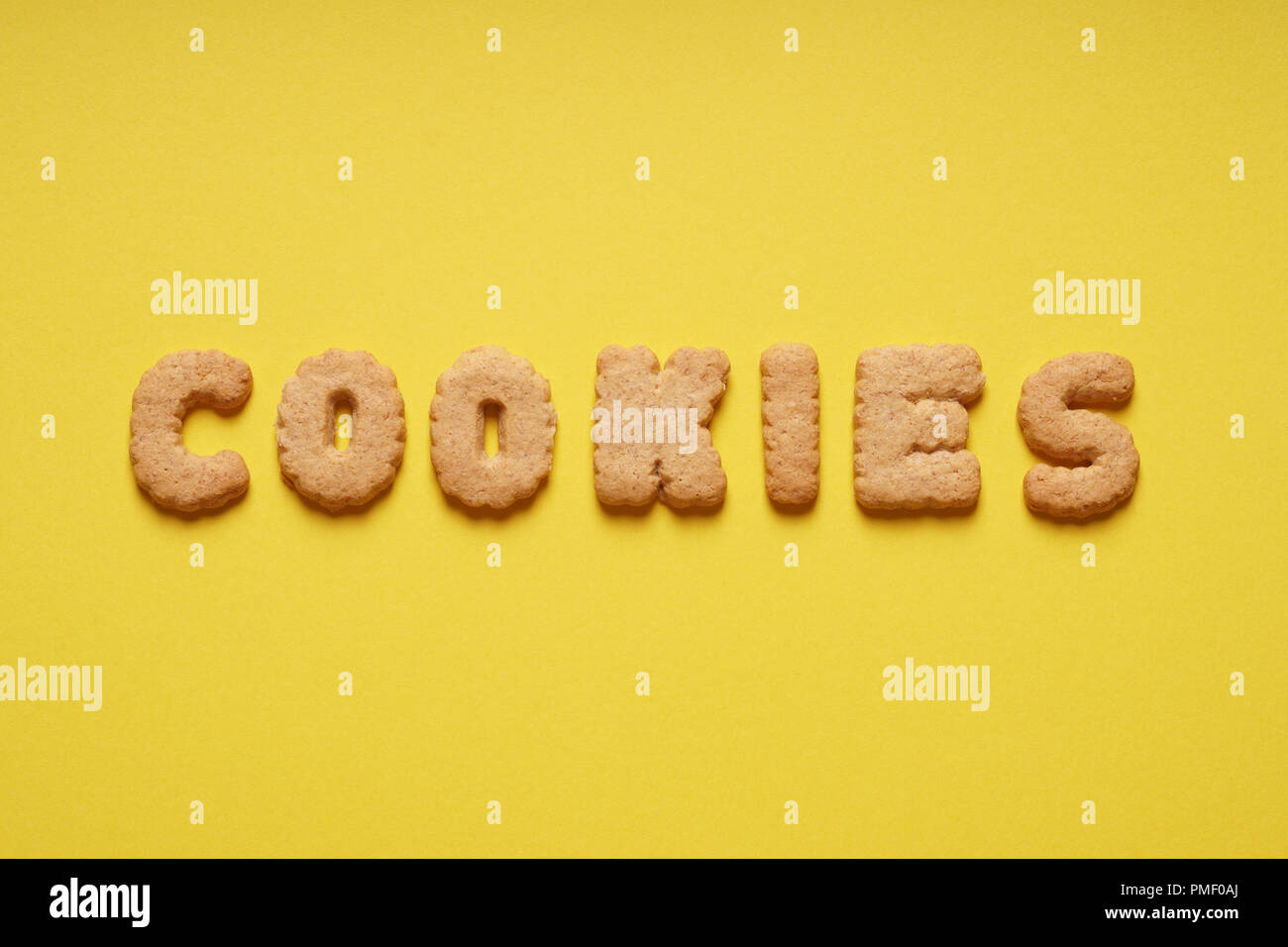cookies word spelled out with cookie letters or characters on yellow paper background Stock Photo
