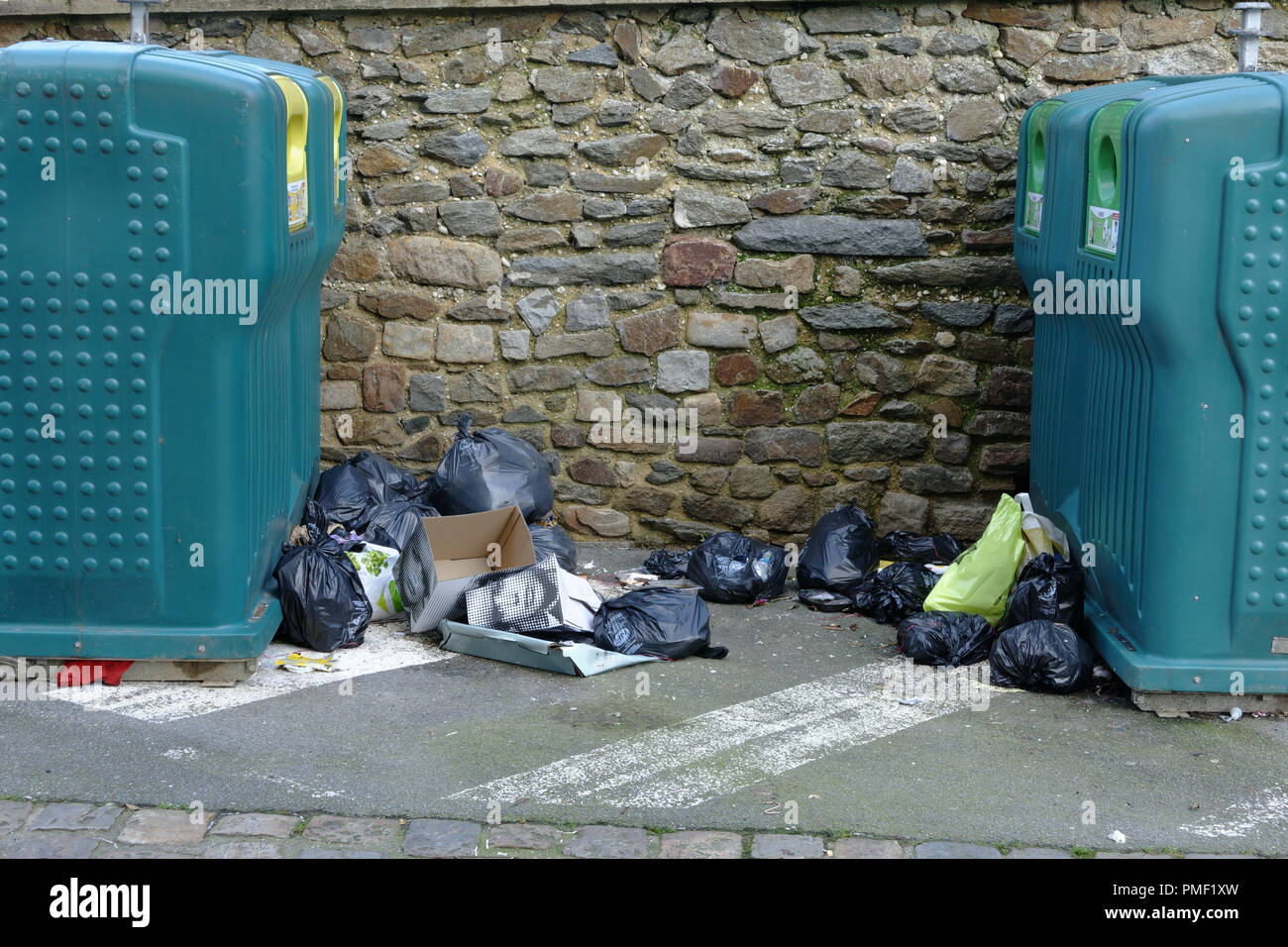 Garbage bags thrown at the bottom of containers for recycling waste, Mayenne city, Pays de la Loire, France Stock Photo