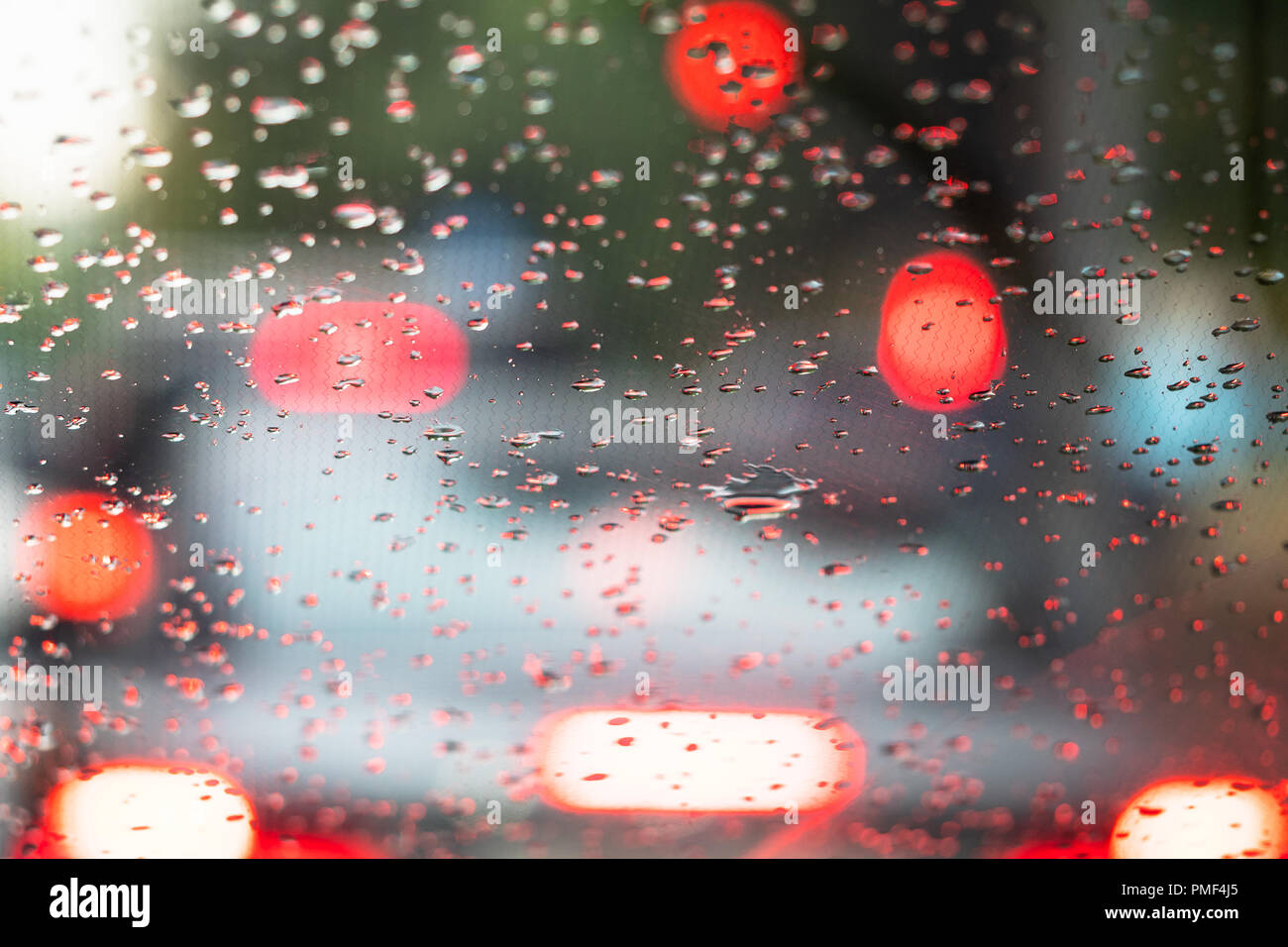 view from the inside onto raindrops on the windshield of the car Stock Photo