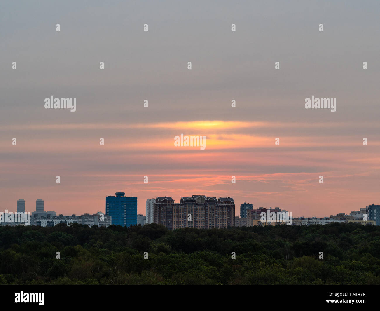 warm autumn dawn over urban houses and park in Moscow city Stock Photo
