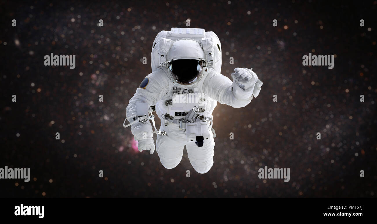 Spaceman. Astronaut in the open space against the background of the galaxy Stock Photo