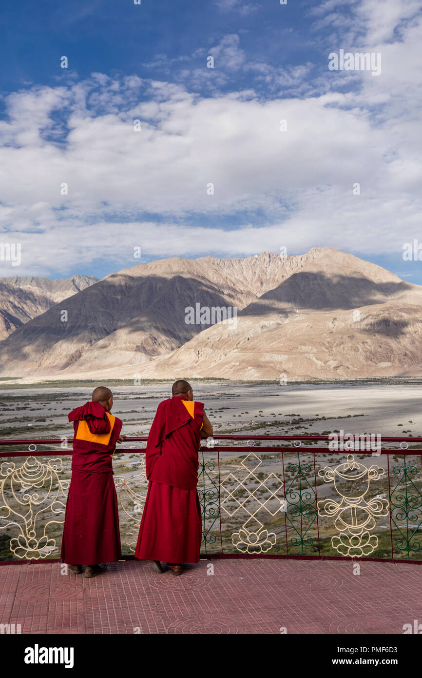 Two monks look at the valley from the Diskit monastery in Numbra valley in the Ladakh region of India Stock Photo