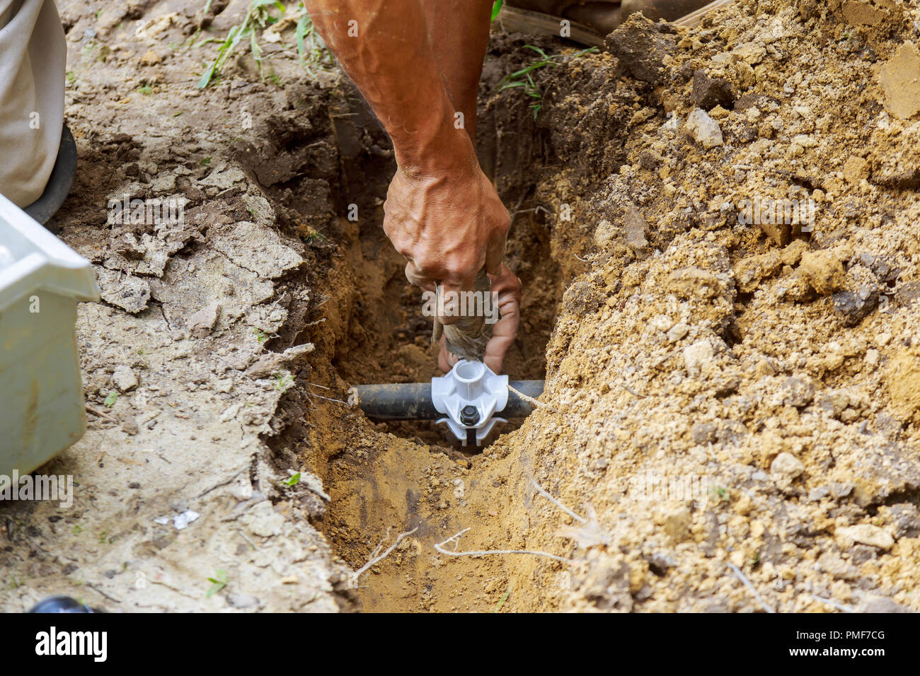 farmer installing irrigation system materials for completing Stock