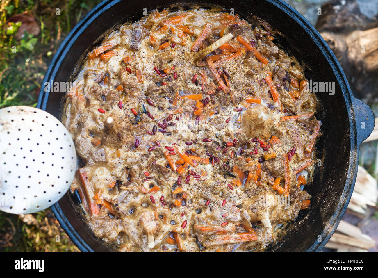 top view of cooking central asian dish plov in kazan pot on oven Stock Photo