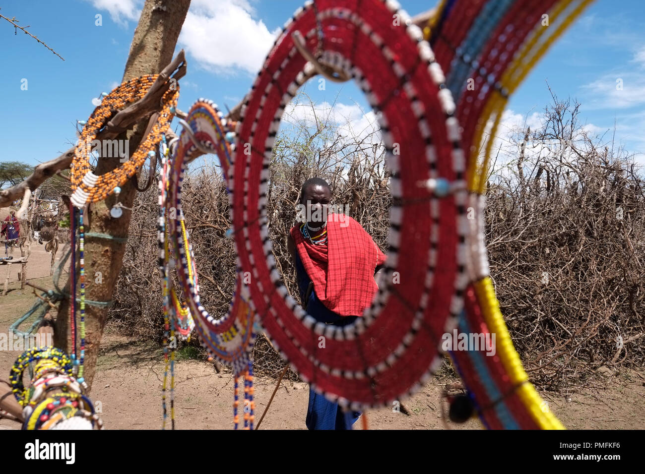 Maasai man seen through traditional maasai jewelry made of colorful