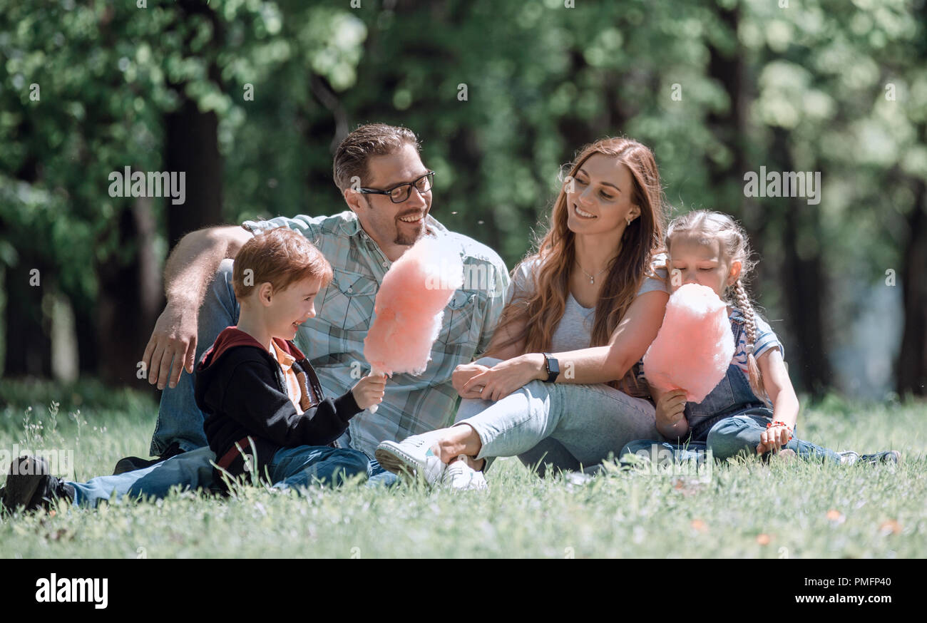 happy family resting on the lawn in the city Park Stock Photo - Alamy