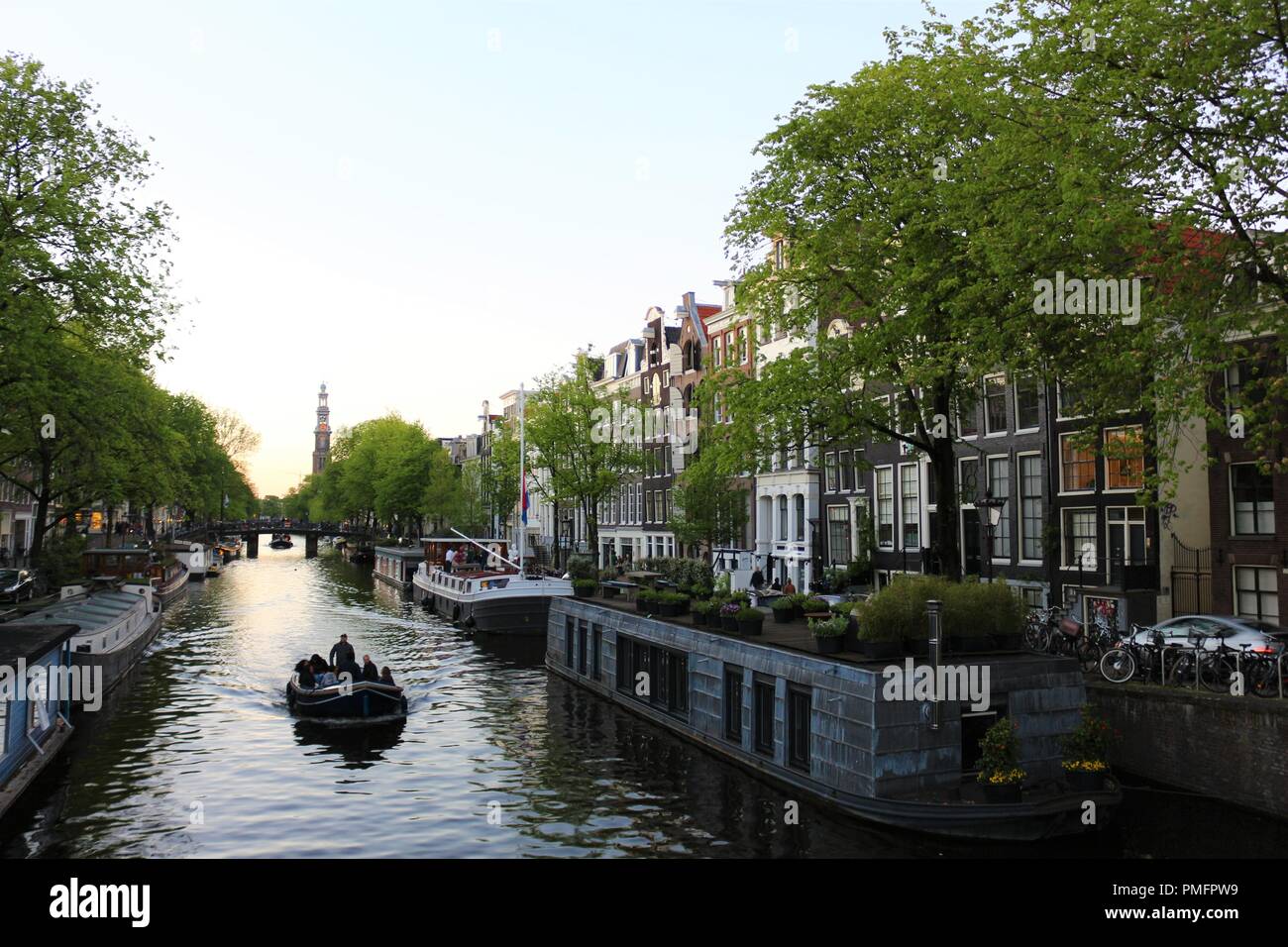 The Waalseilandsgracht canal in Amsterdam. And in the background The Montelbaanstoren Tower that has defended the city through the pass of centuries Stock Photo
