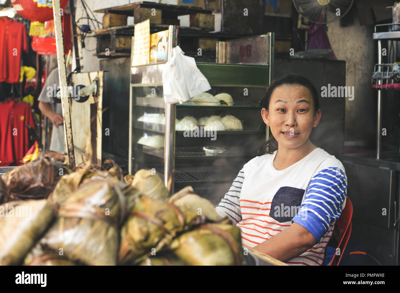 Kuala Lumpur, Malaysia - 9 September, 2017: Chinese street vendor sells sweet rice with coconut in the streets of Kuala Lumpur, Malaysia Stock Photo