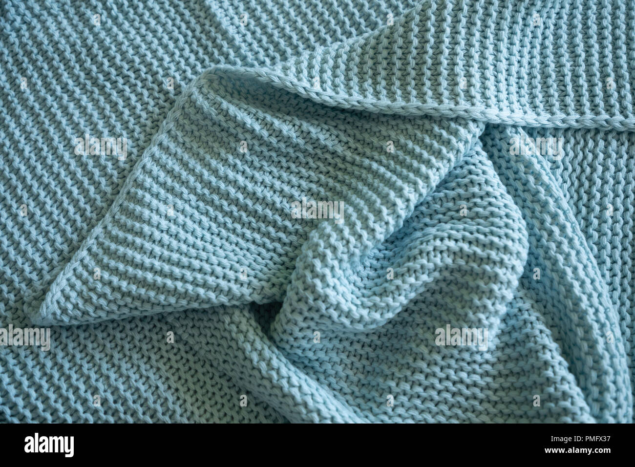Handmade blue knitted wool blanket, texture background Stock Photo