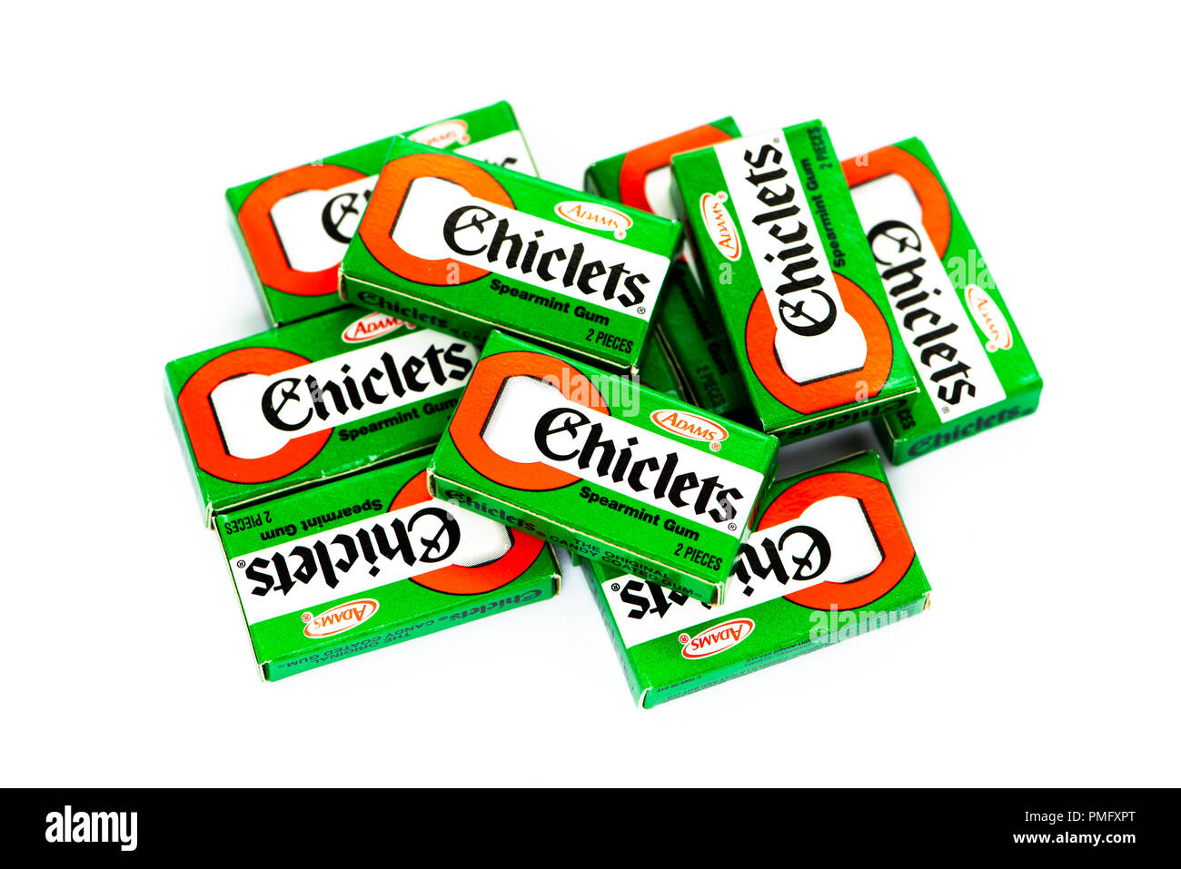A pile of boxes of Adams Chiclets - a brand of candy coated spearmint flavored chewing gum, in individual boxes of 2 pieces. Stock Photo