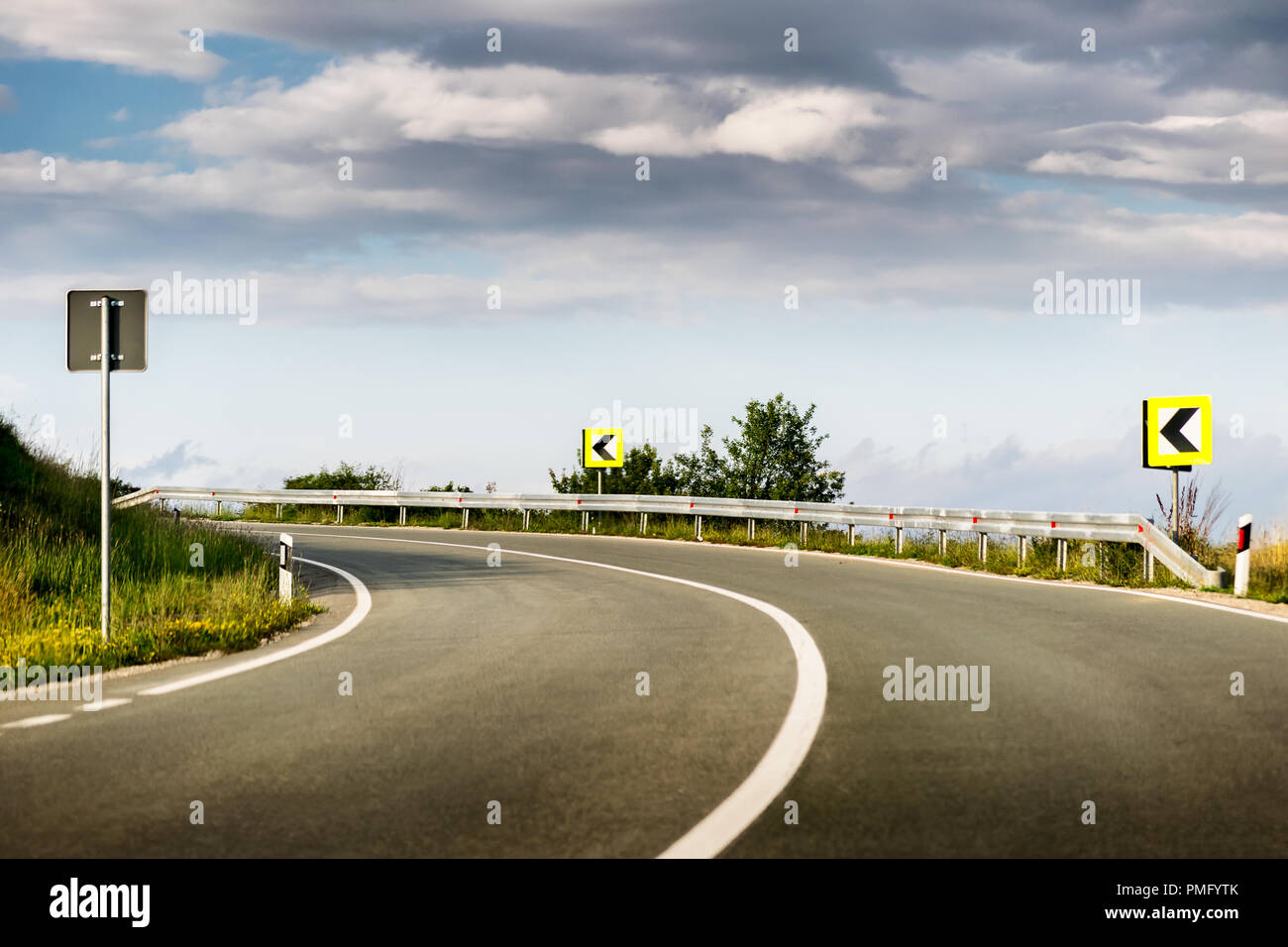 Empty asphalt road winding through beautiful mountains Stock Photo