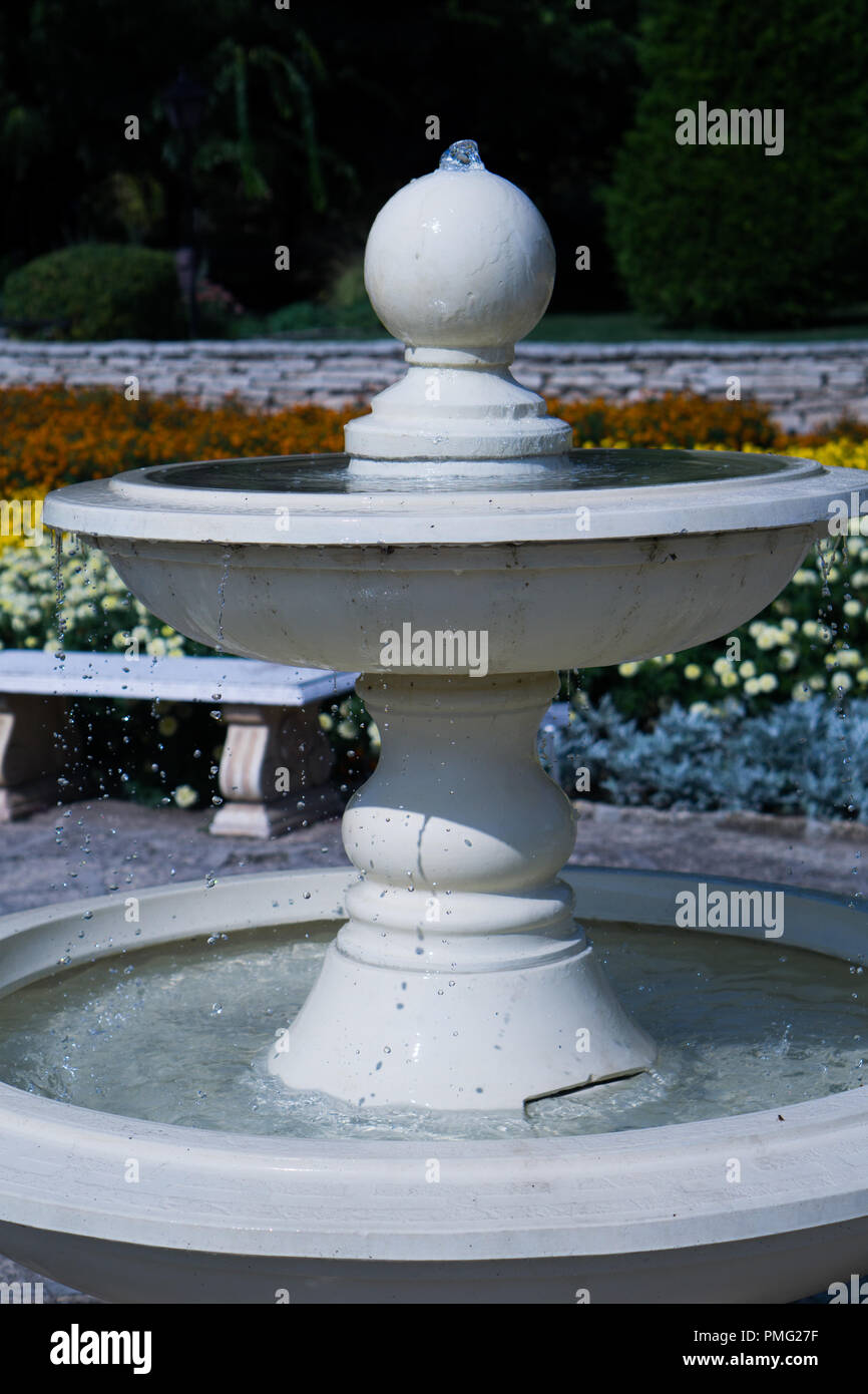 Fountain in a flower garden Stock Photo Alamy