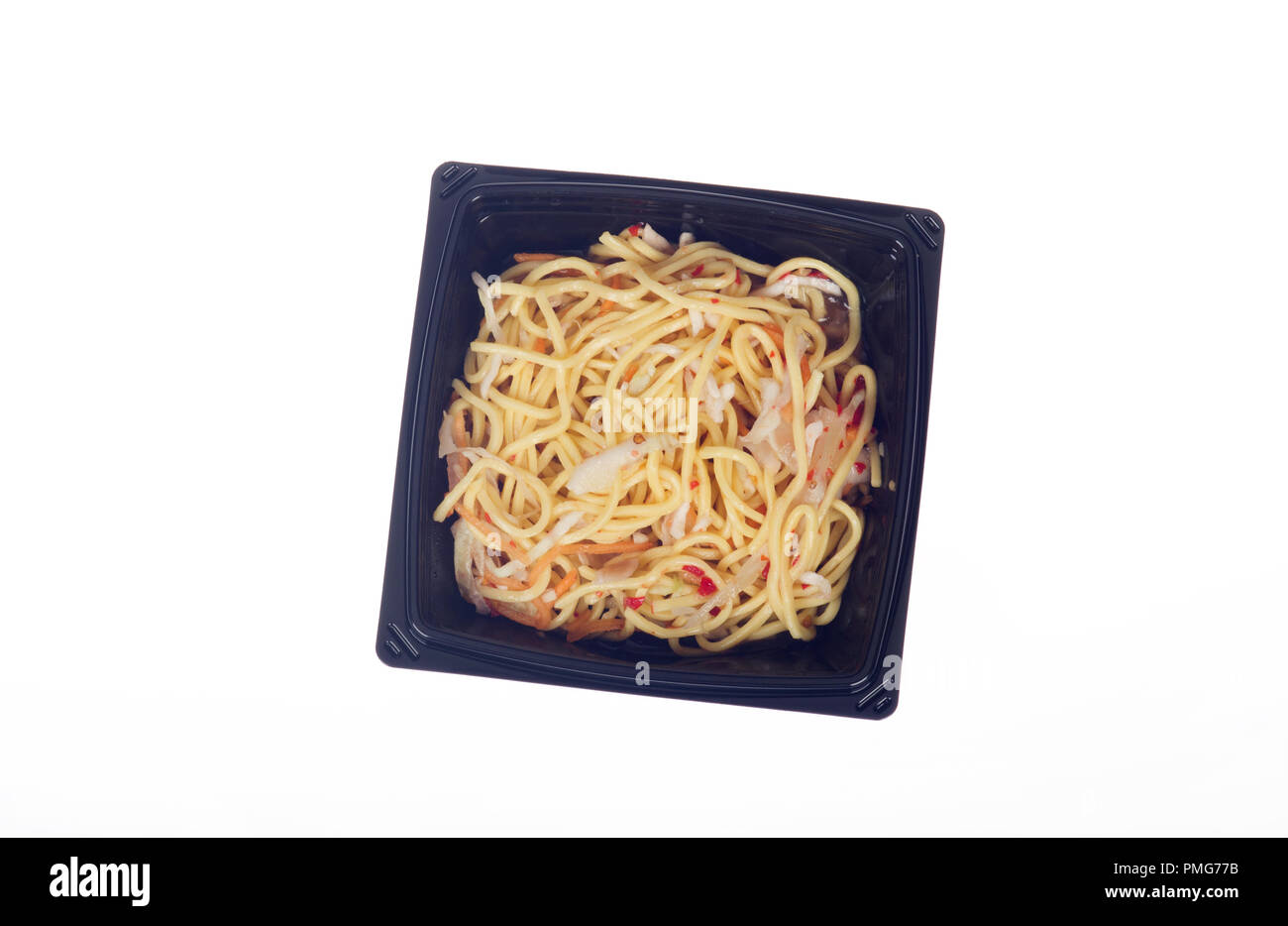 Takeaway or takeout container of prepared food Thai Chili noodles in black plastic on white background Stock Photo