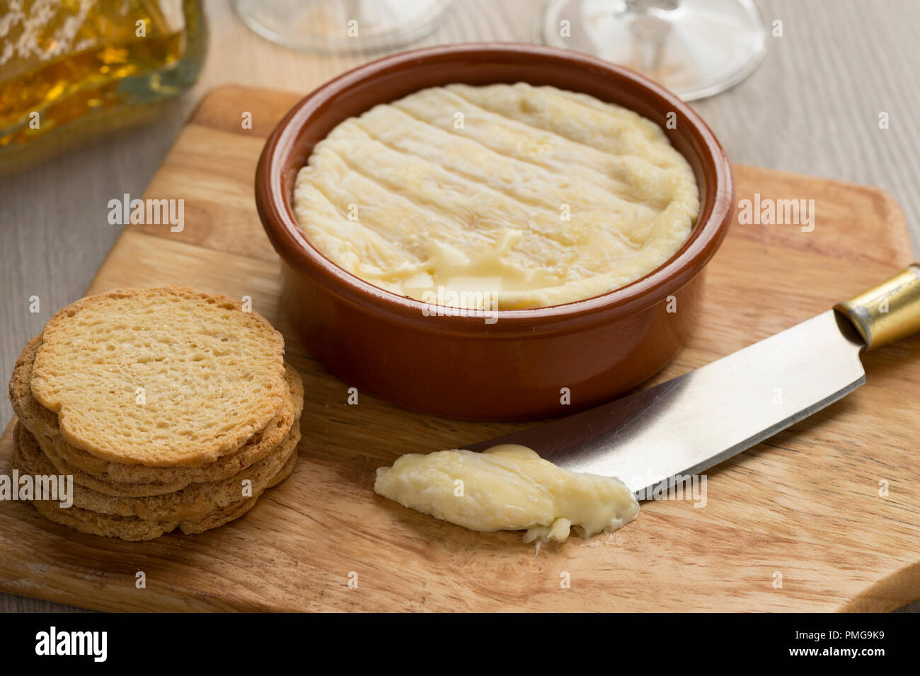 Brown bowl with soft French Saint Marcellin cheese made from cows milk Stock Photo