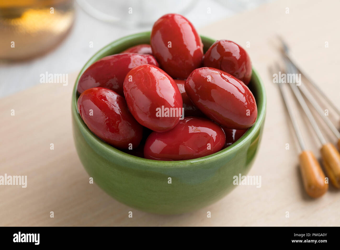 Bowl with red Italian Bella di cerignola olives as snack food Stock Photo