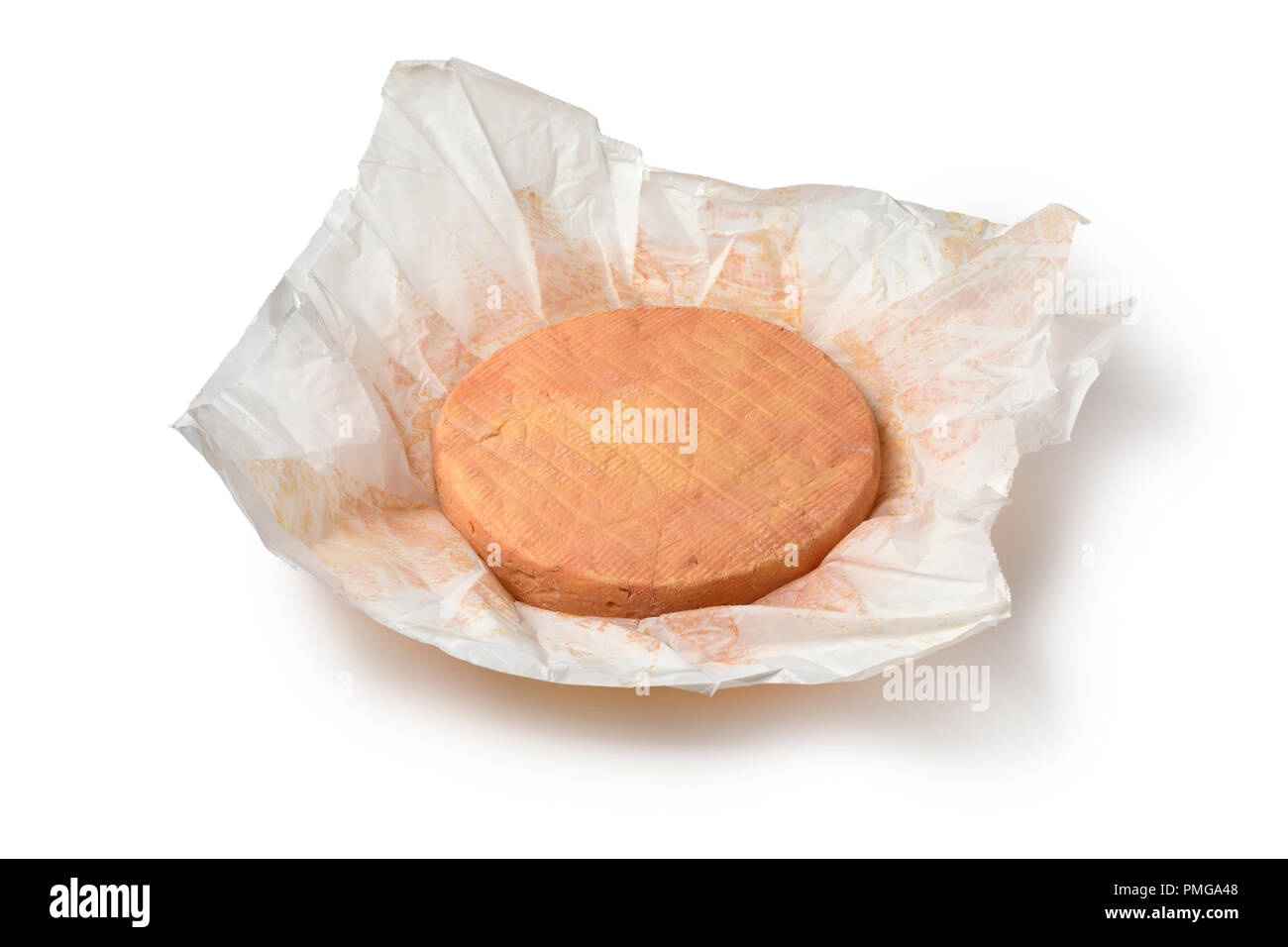 Whole traditional French Munster cheese in paper isolated on white background Stock Photo