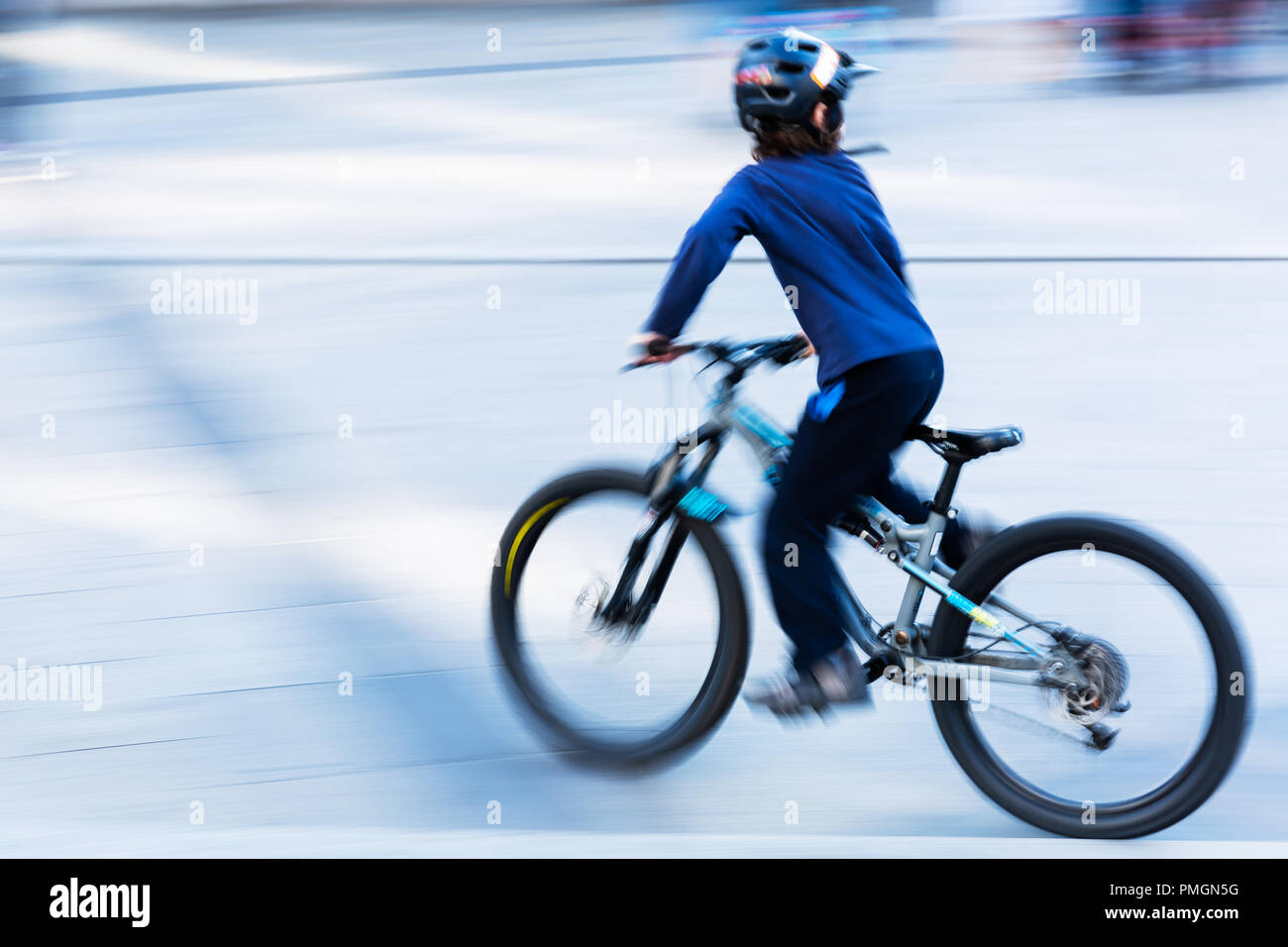 bicycle riding kid in the city in camera made motion blur Stock Photo ...