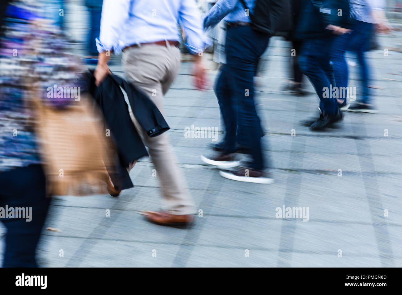 camera made motion blur picture of business people walking in the city ...