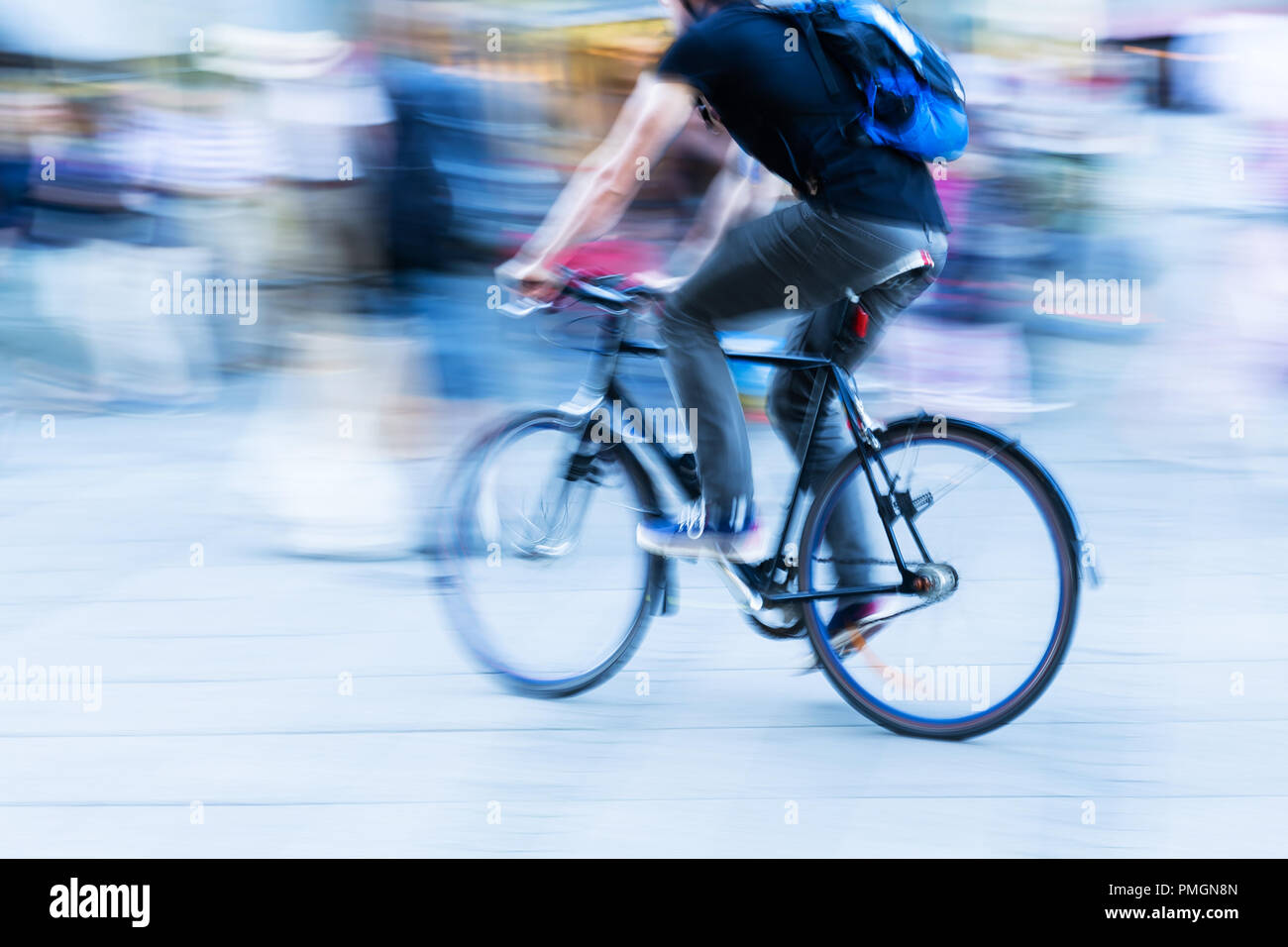 bicycle rider in the city in camera made motion blur Stock Photo - Alamy