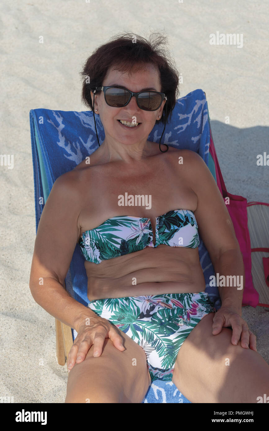 Italy Calabria Middle-aged woman at the beach under an umbrella 2 Stock Photo