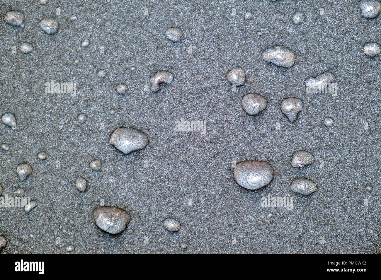 Overnight frost and frozen rain on a car bonnet. Full frame background texture. Stock Photo