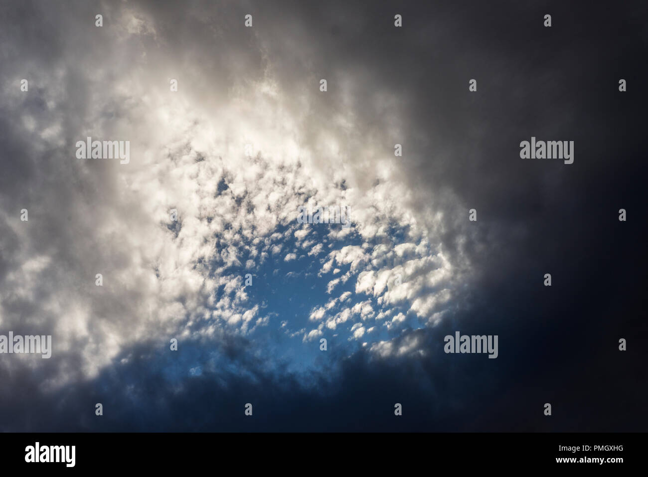 hole between the clouds that shows a part of the sky Stock Photo