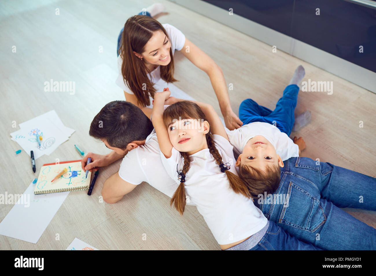 Cheerful family playing together in a room. Stock Photo