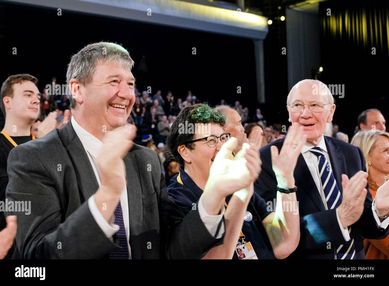 Brighton, UK. 18th September 2018. Willie Rennie is applauded following his speech to the Liberal Democrat Autumn Conference  on Tuesday 18 September 2018 held at Brighton Centre, Sussex. Pictured:  Alistair Carmichael, Commons Chief Whip, Liberal Democrat Spokesperson for Northern Ireland , MP for Orkney and Shetland, and , Menzies Campbell, Liberal Democrat Spokesperson on Defence, congratulate Willie following his speech. Picture by Julie Edwards. Credit: Julie Edwards/Alamy Live News Stock Photo