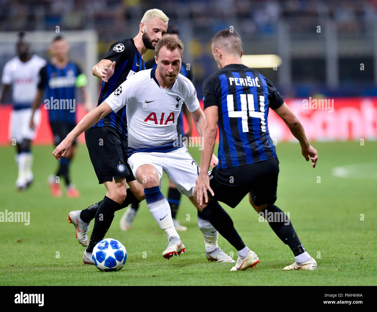 Milan, Italy. 18th September 2018. Christian Eriksen of Tottenham Hotspur  is challenged by Ivan Perisic of Inter Milan during the UEFA Champions  League Group B match between Inter Milan and Tottenham Hotspur, image size:1300x1079
