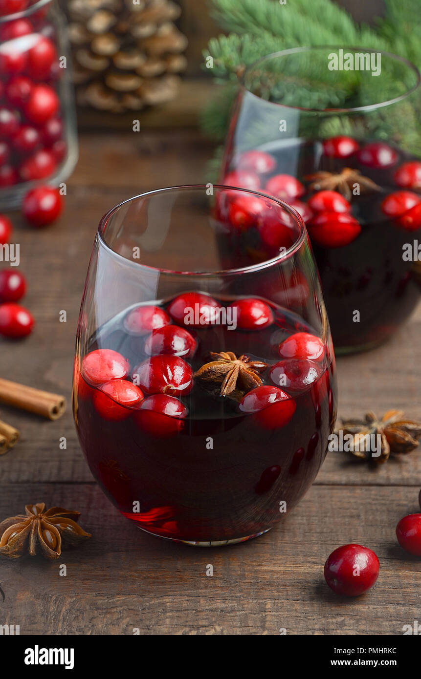 Christmas mulled wine. Holiday concept decorated with Fir branches, Cranberries and Spices. Stock Photo