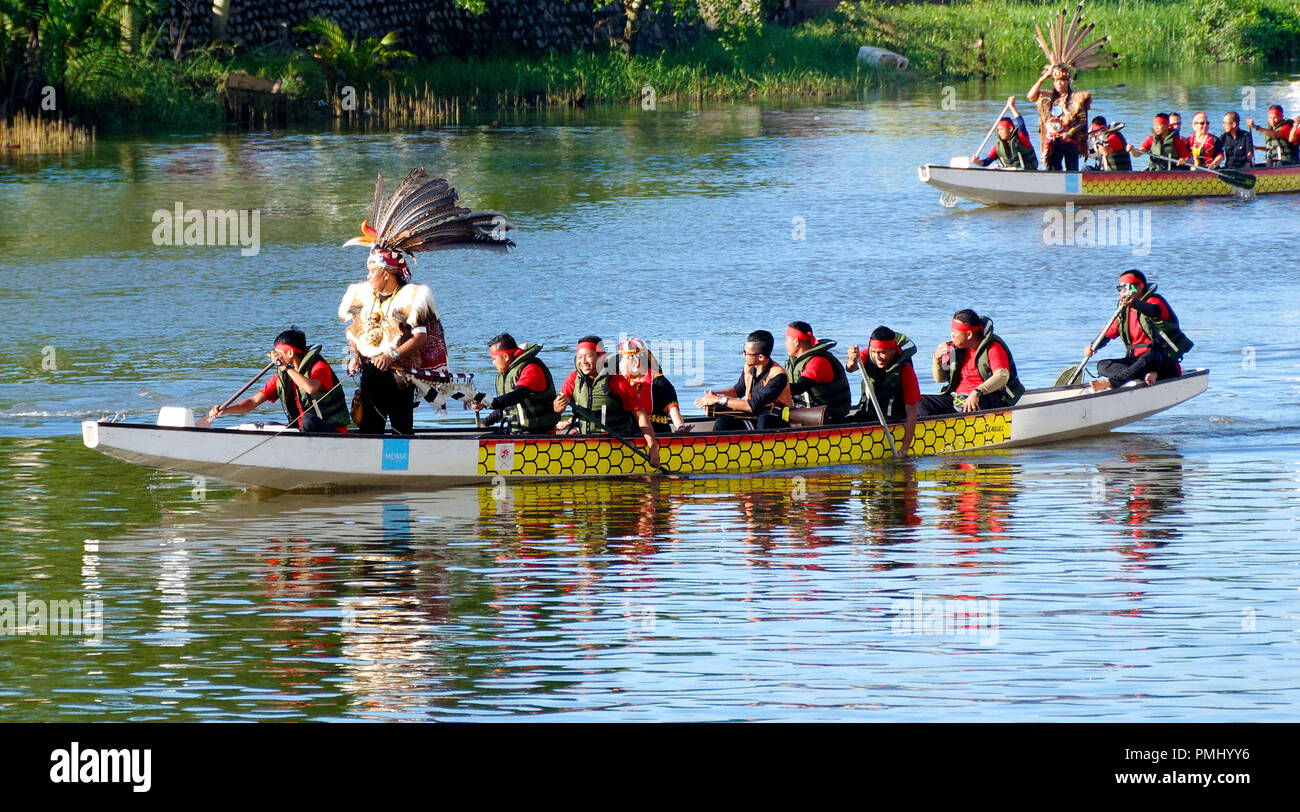 Dragon boat on the Kuching river with Dayak natives in dress Gawai festival Kuching, sarawak Stock Photo