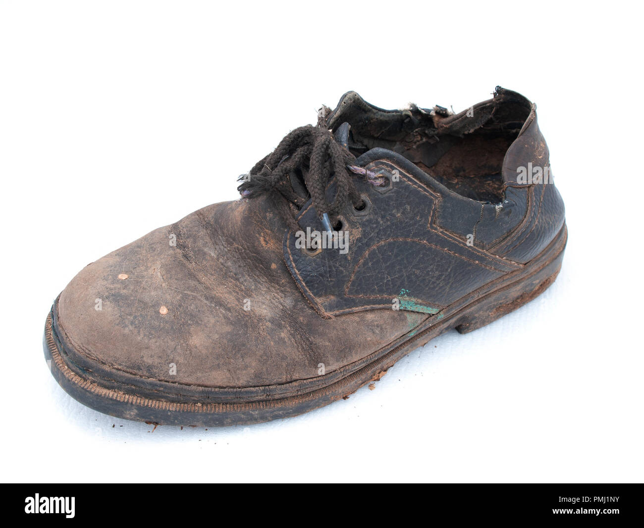 Crazy old shoes on white background. Dirty Old Boots from running in the  rain and mud Stock Photo - Alamy