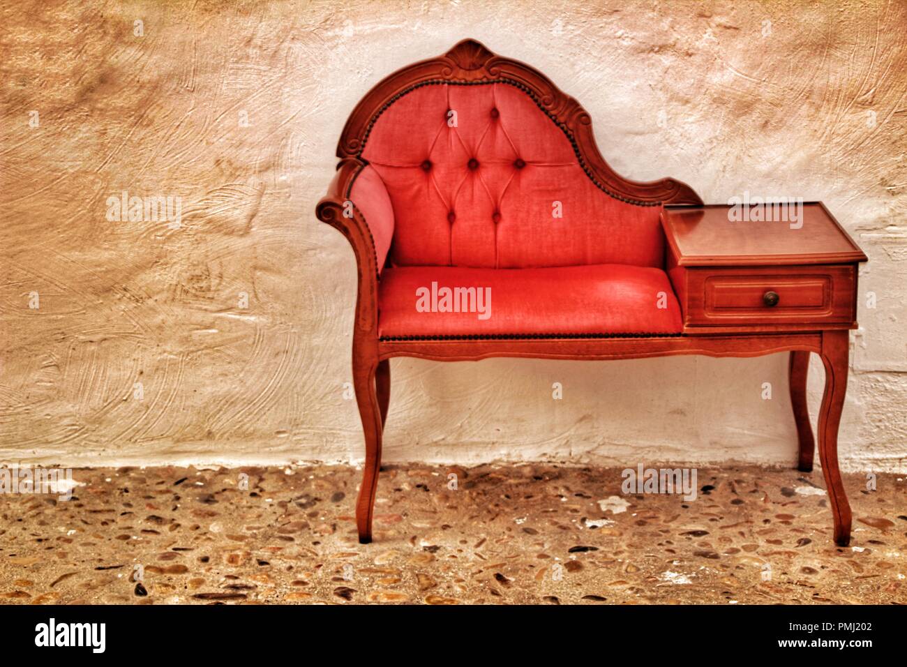 Beautiful and small antique vintage red divan in a cobblestone street in Altea, Spain Stock Photo