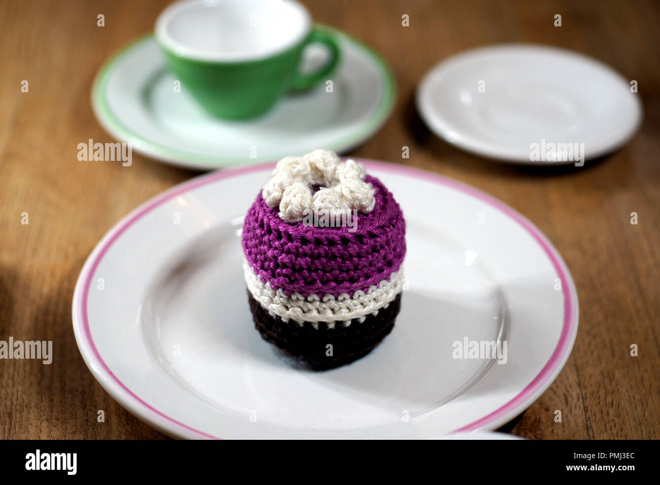 purple crocheted torte at white plate Stock Photo