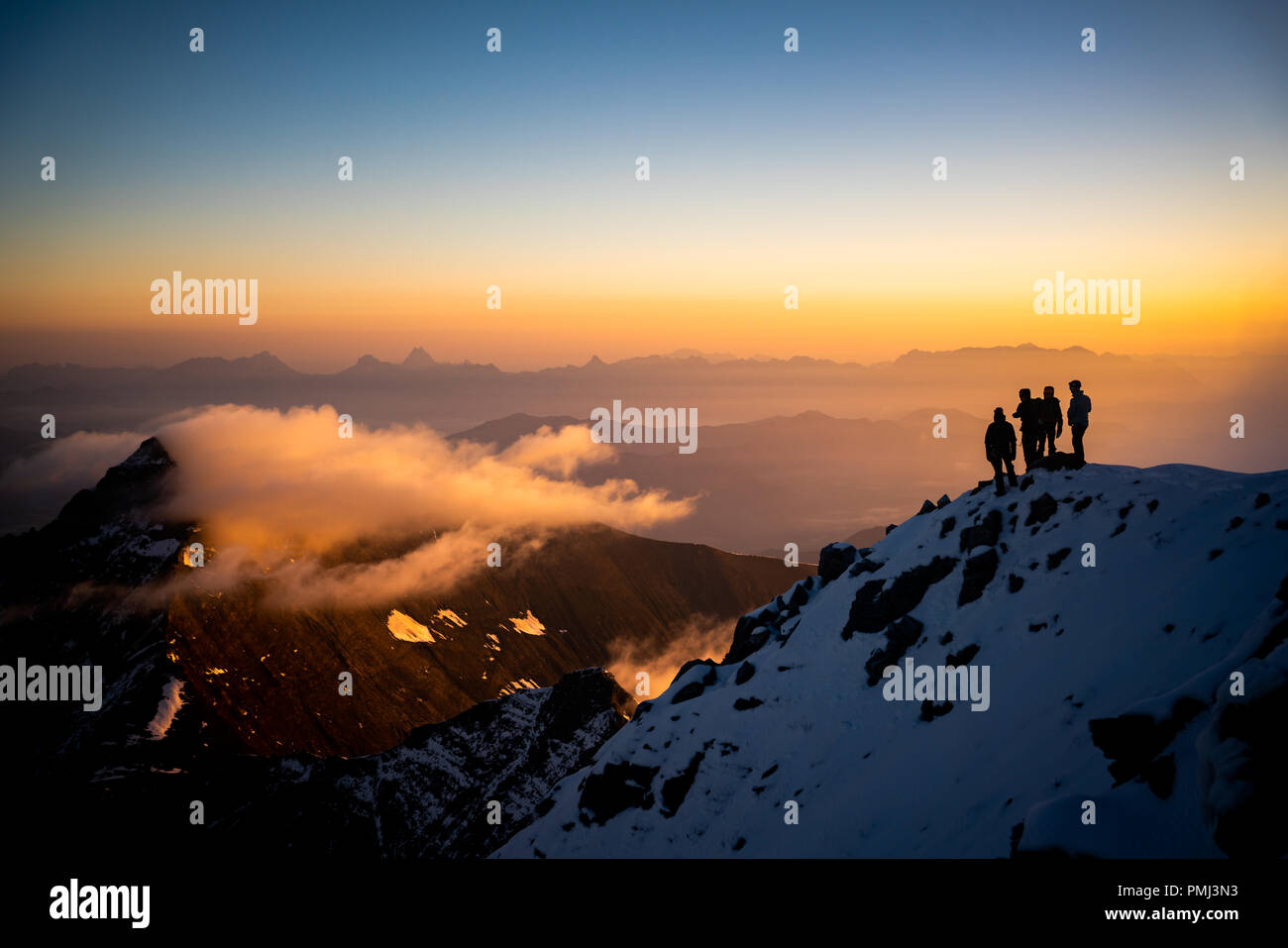 Silhouette of four people on Mt Grosses Wiesbachhorn, Kaprun, Salzburg, Austria Stock Photo