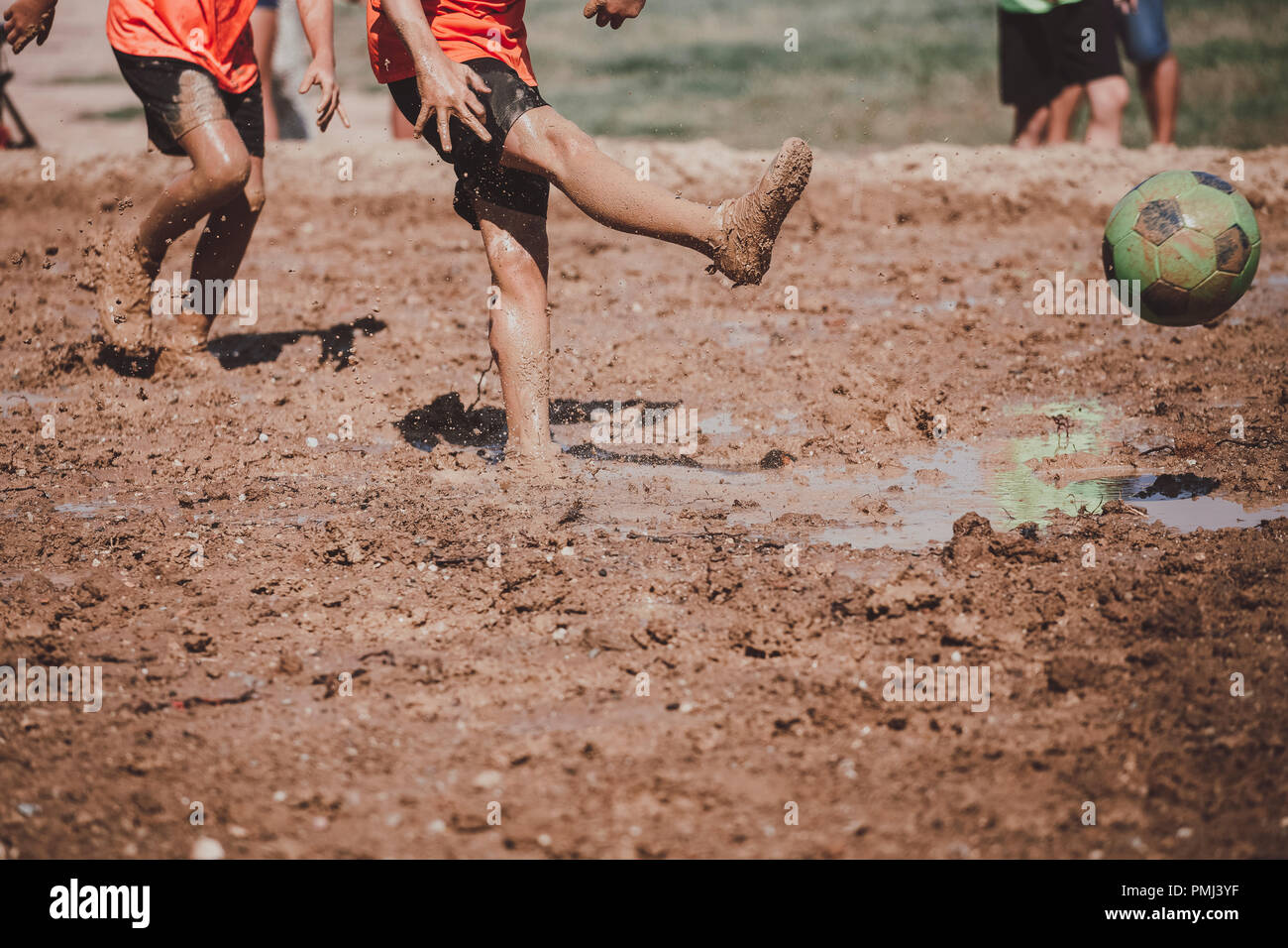 Children playing football in the mud Stock Photo Alamy