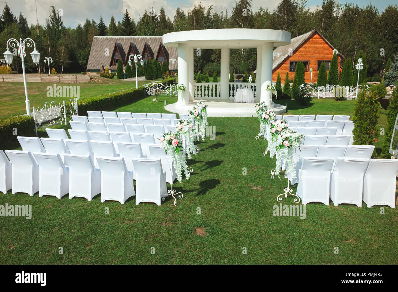 The Ceremony Of Marriage In The Open Air In The Summer Place Of A Wedding With White Chairs And Beautiful Flowers Stock Photo Alamy