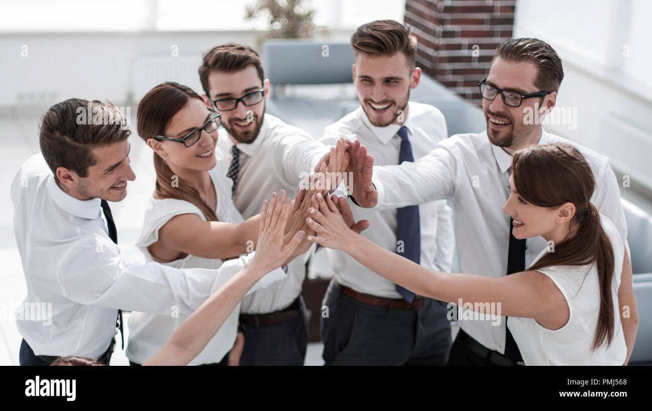 young business team giving each other high five Stock Photo - Alamy