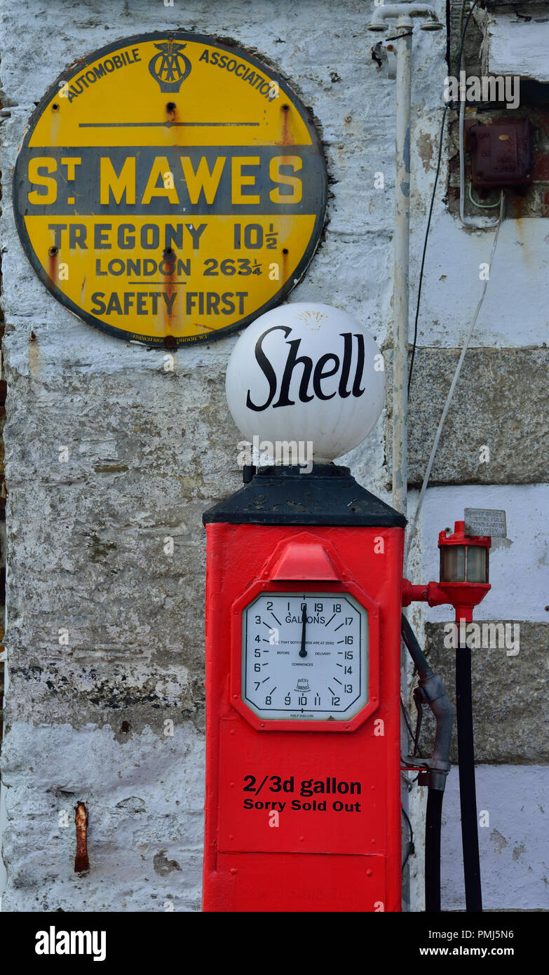 Vintage petrol pumps on the quayside road in the picturesque seaside village of St Mawes on the Roseland Peninsula, Cornwall, South West England, UK Stock Photo