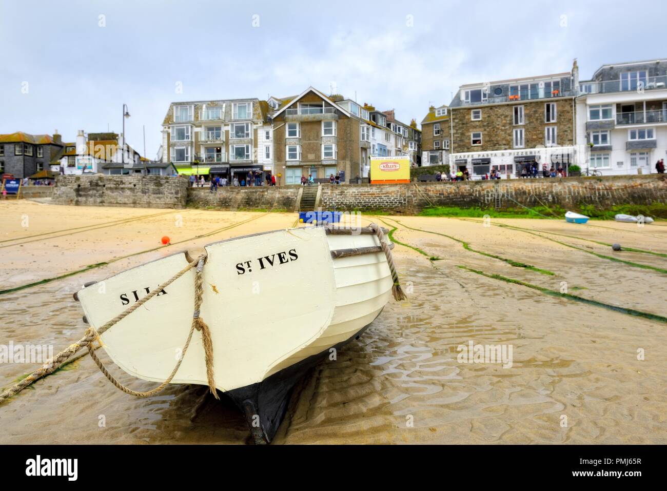 A boat in St Ives Harbour at low tide,Cornwall,England,UK Stock Photo