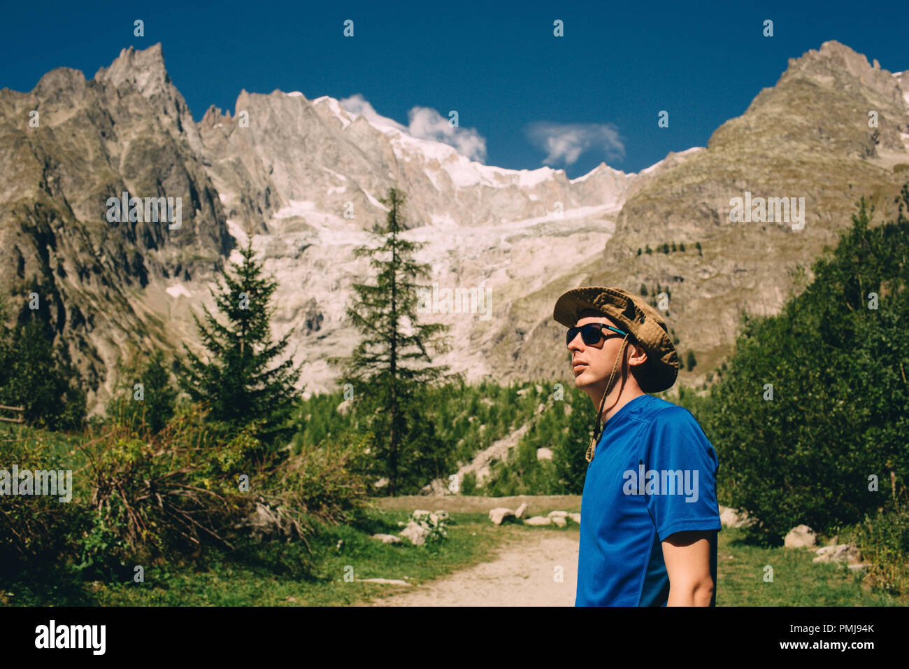 tourist wearing hat and sunglasses ,on european alps background Stock Photo