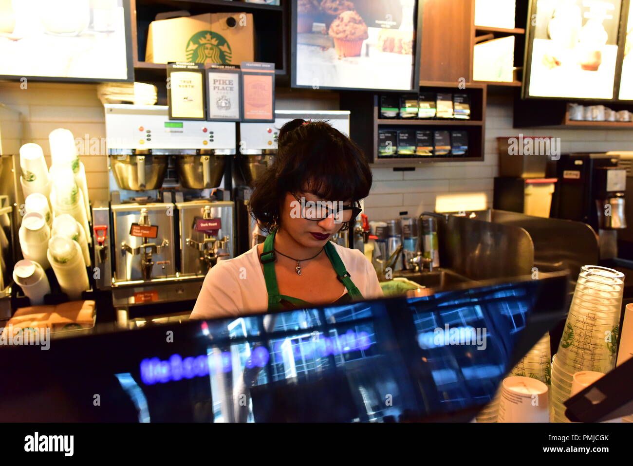 Coffee shop employee rings up a sale inside the Union Station in