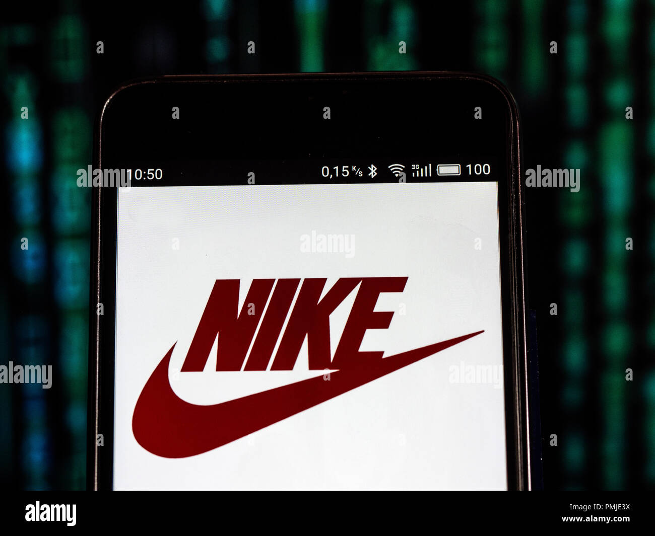 Nike Footwear manufacturing company logo seen displayed on a smart phone.  Nike, Inc. is an American multinational corporation that is engaged in the  design, development, manufacturing, and worldwide marketing and sales of