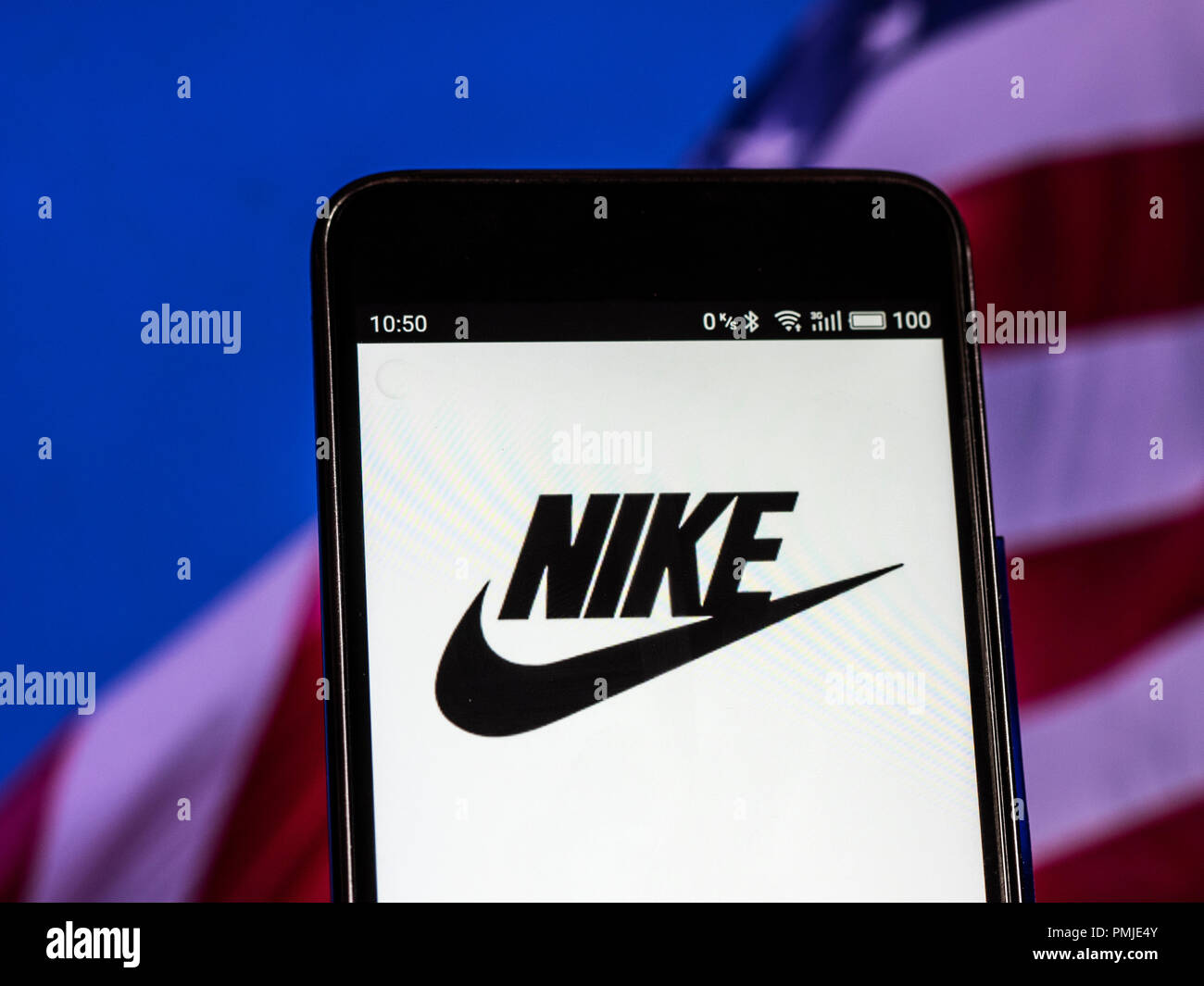 Nike Footwear manufacturing company logo seen displayed on a smart phone.  Nike, Inc. is an American multinational corporation that is engaged in the  design, development, manufacturing, and worldwide marketing and sales of