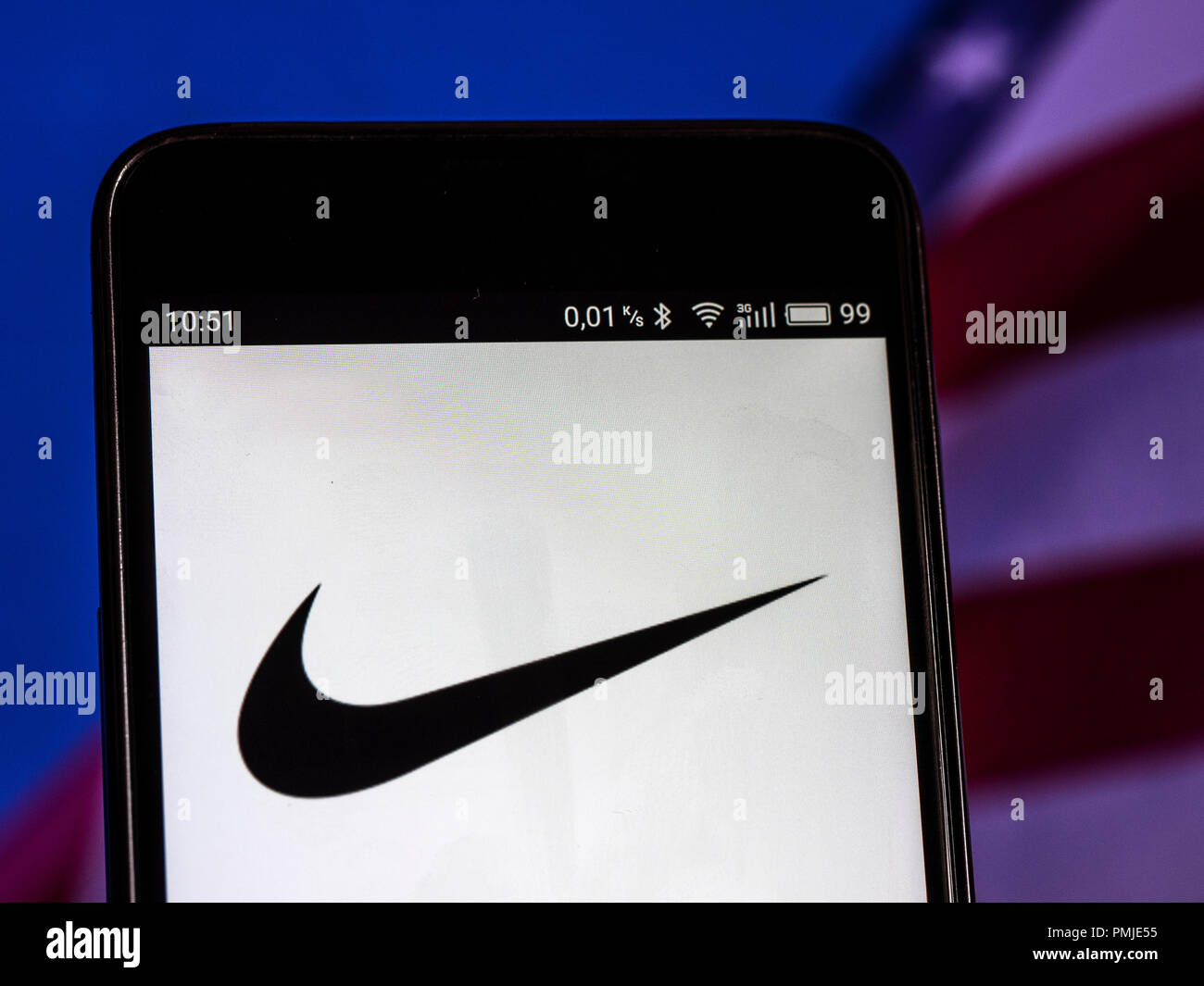 Nike Footwear manufacturing company logo seen displayed on a smart phone.  Nike, Inc. is an American multinational corporation that is engaged in the  design, development, manufacturing, and worldwide marketing and sales of